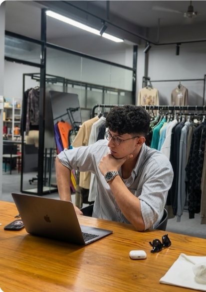 Abdessamad on a call at his laptop in the showroom