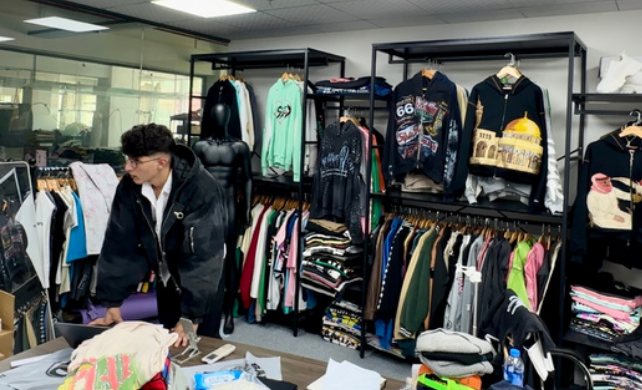 Reviewing garment racks while preparing a bulk order